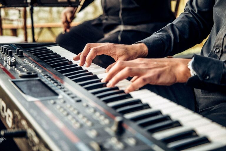 Musicians’ hands playing a keyboard during a gospel-style performance